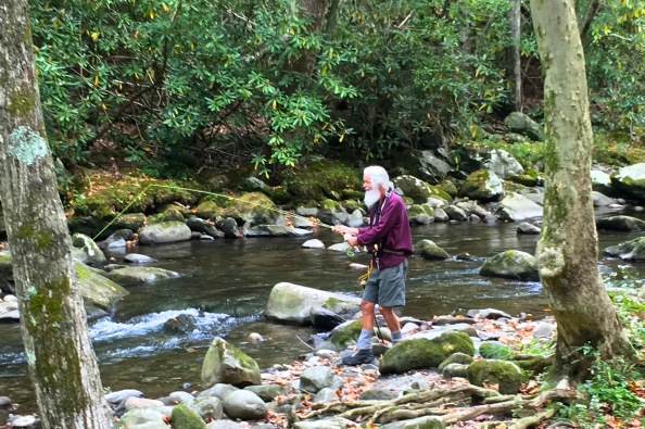 Standing by the river with a stick in my hand in the Great Smoky Mountains.